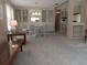 Living room with wall shelving, dining area, and view into kitchen at 320 Tropic Dr, Osprey, FL 34229
