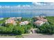 Beautiful aerial view of a condo complex with a pool, manicured lawns, and a secure entrance at 340 Gulf Of Mexico Dr # 136, Longboat Key, FL 34228