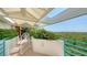 Balcony with tile flooring, railing, colorful flowerbeds, and stunning views of the bay at 340 Gulf Of Mexico Dr # 136, Longboat Key, FL 34228