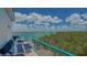 Relax on this beautiful balcony with seating and enjoy stunning views of the water and clear blue skies at 340 Gulf Of Mexico Dr # 136, Longboat Key, FL 34228