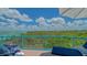 Relaxing balcony with panoramic view, outdoor seating, blue railings, and peaceful view at 340 Gulf Of Mexico Dr # 136, Longboat Key, FL 34228