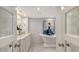 Clean and modern primary bathroom with double vanity, soaking tub, and elegant finishes at 340 Gulf Of Mexico Dr # 136, Longboat Key, FL 34228