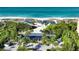 Aerial view of the beach club with beach access, picnic pavilions, and beautiful turquoise waters at 340 Gulf Of Mexico Dr # 136, Longboat Key, FL 34228