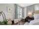 Bedroom sitting area with a side table and a view of the greenery outside at 340 Gulf Of Mexico Dr # 136, Longboat Key, FL 34228