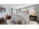 Bright bedroom features a king bed, side tables, and large windows with sheer curtains at 340 Gulf Of Mexico Dr # 136, Longboat Key, FL 34228