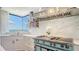 Gourmet kitchen showcasing a striking range, stainless hood, marble accents, and picturesque bay views at 340 Gulf Of Mexico Dr # 136, Longboat Key, FL 34228