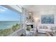 Living room highlighting water views, fireplace, and stylish decor at 340 Gulf Of Mexico Dr # 136, Longboat Key, FL 34228