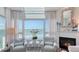Living room boasting water views, fireplace, and comfortable seating at 340 Gulf Of Mexico Dr # 136, Longboat Key, FL 34228