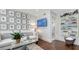 Bright living room features a modern couch, a clear coffee table, and a wall of framed art at 340 Gulf Of Mexico Dr # 136, Longboat Key, FL 34228