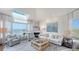 Bright living room showcasing water views, a fireplace, and stylish decor at 340 Gulf Of Mexico Dr # 136, Longboat Key, FL 34228