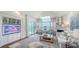 Bright living room featuring water views, fireplace, and built-in shelving with television at 340 Gulf Of Mexico Dr # 136, Longboat Key, FL 34228