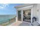 Patio opens to living room with water views and glass railings at 340 Gulf Of Mexico Dr # 136, Longboat Key, FL 34228