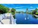 Scenic pond with a fountain, swans, and a charming bridge, creating a serene atmosphere at 340 Gulf Of Mexico Dr # 136, Longboat Key, FL 34228