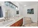 Bright bathroom features double sinks, garden tub, and picture window for natural light at 3905 Trentwood Pl, Sarasota, FL 34243