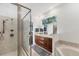 This bathroom offers a glass shower and wood vanity, with neutral countertops and tiles at 3905 Trentwood Pl, Sarasota, FL 34243