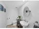 Small powder room with a pedestal sink, artwork, and decorative accent for guests at 3905 Trentwood Pl, Sarasota, FL 34243