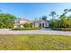 Beautiful home with lush landscaping, circular driveway, and a tile roof at 3905 Trentwood Pl, Sarasota, FL 34243