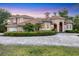 Attractive property with a paved driveway, manicured hedges, and a well-maintained lawn at 3905 Trentwood Pl, Sarasota, FL 34243