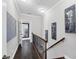 Hallway with hardwood floors and artwork at 3905 Trentwood Pl, Sarasota, FL 34243