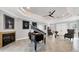 Elegant living room with tile floors, a fireplace, tray ceiling, and grand piano at 3905 Trentwood Pl, Sarasota, FL 34243
