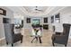 Open-concept living room featuring tile floors, high ceilings, fireplace, and grand piano at 3905 Trentwood Pl, Sarasota, FL 34243