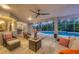 Relaxing screened patio with plush seating overlooking the pool and lush greenery at 3905 Trentwood Pl, Sarasota, FL 34243