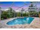 Serene backyard pool with a spa and lovely landscaping within a screened enclosure at 3905 Trentwood Pl, Sarasota, FL 34243