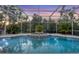 Beautiful screened-in pool with a water feature and ample space for entertaining at 3905 Trentwood Pl, Sarasota, FL 34243