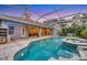 Inviting pool area with an attached spa, surrounded by a patio and lush greenery in a screened enclosure at 3905 Trentwood Pl, Sarasota, FL 34243