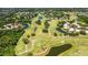 Expansive aerial view of a golf course community featuring lush fairways, water hazards, and beautiful homes at 4044 Penshurst Park, Sarasota, FL 34235