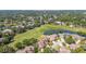 An aerial view of a house, with golf course and pond at 4044 Penshurst Park, Sarasota, FL 34235