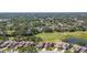 An aerial view of a house, with golf course and pond at 4044 Penshurst Park, Sarasota, FL 34235