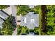 Aerial view of a well-maintained home with lush landscaping and a long driveway at 4044 Penshurst Park, Sarasota, FL 34235