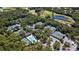 An aerial view showing the pool, tennis courts, and other recreational amenities of this community at 4044 Penshurst Park, Sarasota, FL 34235
