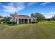 Well-maintained backyard featuring a lush lawn, screened lanai, and picturesque golf course views at 4044 Penshurst Park, Sarasota, FL 34235
