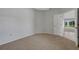 Neutral bedroom overlooking the yard via a sliding glass door at 4044 Penshurst Park, Sarasota, FL 34235