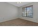 Comfortable bedroom featuring neutral carpet, and a window that brings in natural light at 4044 Penshurst Park, Sarasota, FL 34235