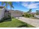 Well-maintained home featuring a two-car garage, paver driveway, manicured lawn, and lush landscaping at 4044 Penshurst Park, Sarasota, FL 34235
