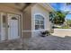 Inviting front porch with brick pavers, decorative planters, and a view of the front door at 4044 Penshurst Park, Sarasota, FL 34235