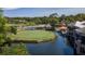 Scenic view of the golf course featuring lush greenery, a serene pond, and the community clubhouse at 4044 Penshurst Park, Sarasota, FL 34235