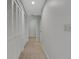 Hallway with double closets leading to another room and full bathroom at 4044 Penshurst Park, Sarasota, FL 34235