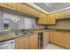 Well-appointed kitchen with granite countertops, custom cabinetry, and stainless steel appliances at 4044 Penshurst Park, Sarasota, FL 34235