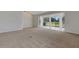 Living room showcasing sliding glass doors leading to lanai and golf course view at 4044 Penshurst Park, Sarasota, FL 34235