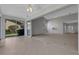 Open-concept room with carpet, a chandelier, and sliding doors to a sunroom at 4044 Penshurst Park, Sarasota, FL 34235