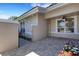 Charming patio with brick pavers, decorative gate, and lush flower bed at 4044 Penshurst Park, Sarasota, FL 34235