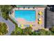 Aerial view of the community pool with inviting blue water and comfortable lounge chairs around the deck at 4044 Penshurst Park, Sarasota, FL 34235