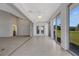 Bright sunroom with tile floor and large windows providing scenic backyard views at 4044 Penshurst Park, Sarasota, FL 34235