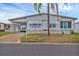 Charming single-story home featuring a covered carport, turquoise door, and tropical landscaping at 4312 14Th E St, Ellenton, FL 34222