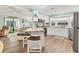 Open-concept kitchen with a breakfast bar that connects to the living room, stainless steel appliances and light cabinets at 4312 14Th E St, Ellenton, FL 34222