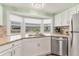 Modern kitchen features stainless steel dishwasher and sink, a window view to backyard and granite countertops at 4312 14Th E St, Ellenton, FL 34222